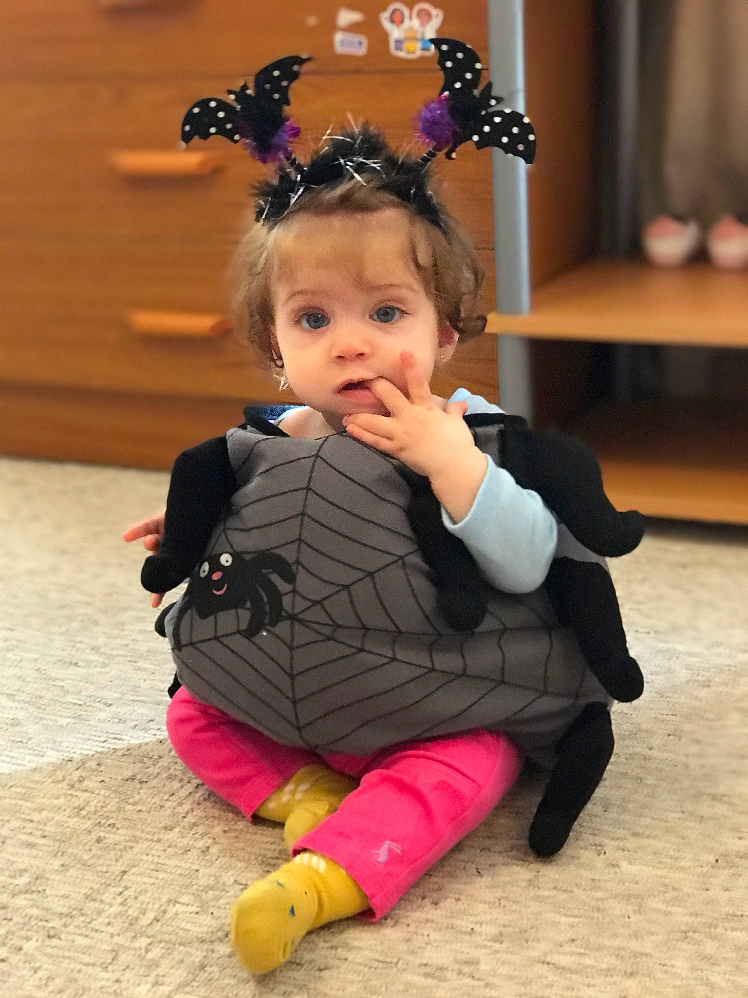 Erika is registered to the contest to win money with this photo: baby, baby_toddler_clothing, cheek, child, event, eye, face, fashion_accessory, floor, flooring, fun, fur, hair, happy, head, jewellery, leisure, person, sitting, surprise