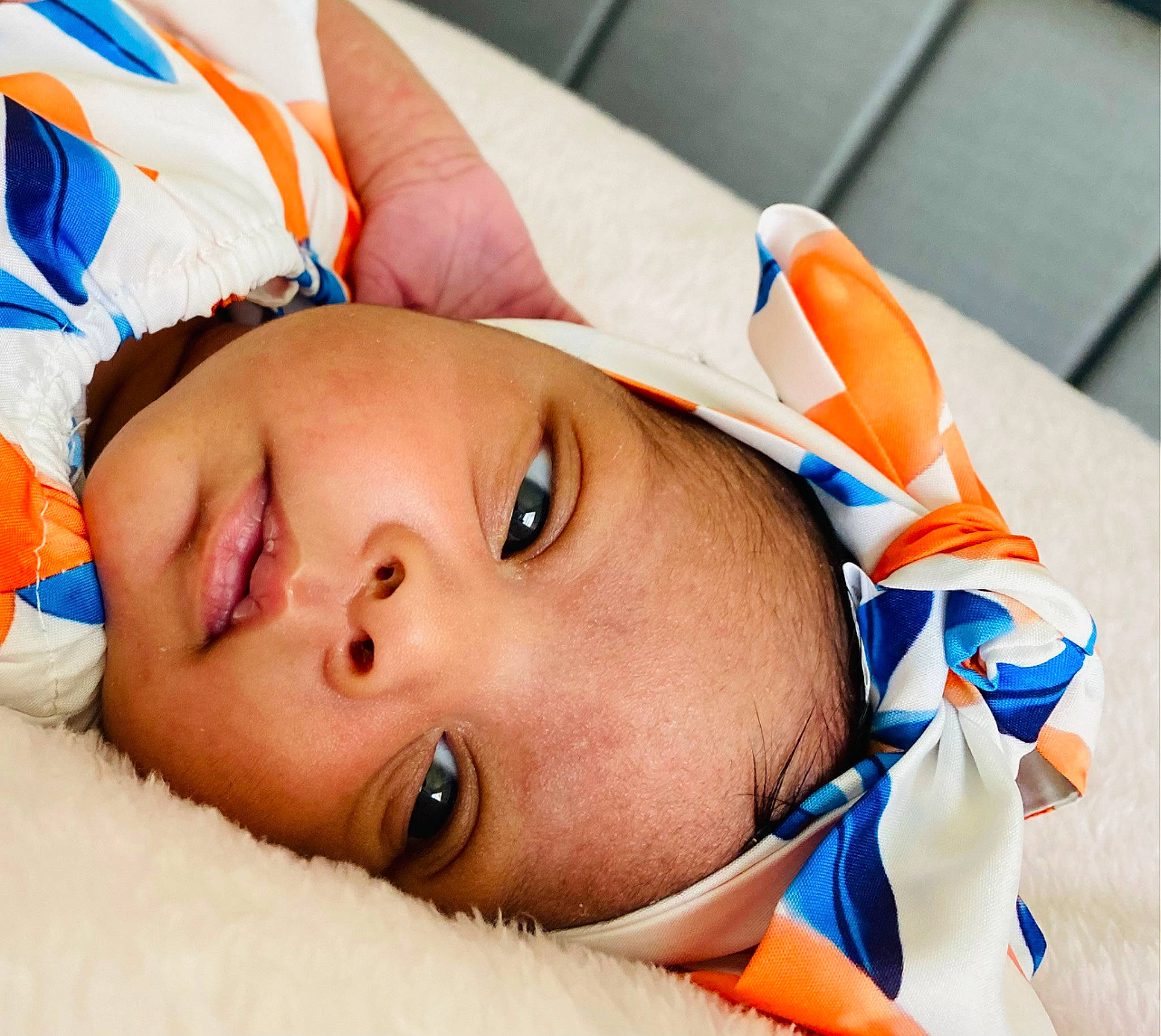 Arianna is registered to the contest to win money with this photo: abdomen, baby, baby_sleeping, cheek, chest, child, comfort, eye, eyebrow, eyelash, fashion_accessory, finger, happy, hat, lip, mouth, nose, orange, person, skin