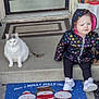 Mama Gurl is registered to the contest to win money with this photo: cat, concrete_step, door_rug, doormat, flower_pot, front_door, heart_pattern, hooded_jacket, leggings, planter, porch, puppy, siding, sitting, sneakers, snowman_mat, toddler, umbrella, welcome_mat, yellow_shovel