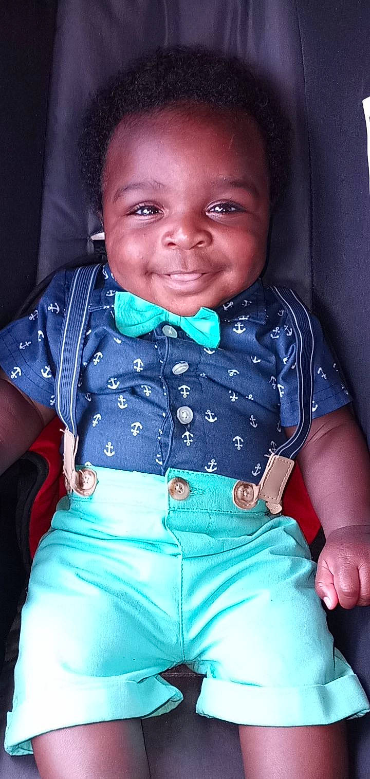 Alija is registered to the contest to win money with this photo: arm, azure, baby_toddler_clothing, chin, clothing, eye, face, facial_expression, flash_photography, hairstyle, hand, joy, lip, mouth, organ, outerwear, person, shoulder, skin, sleeve