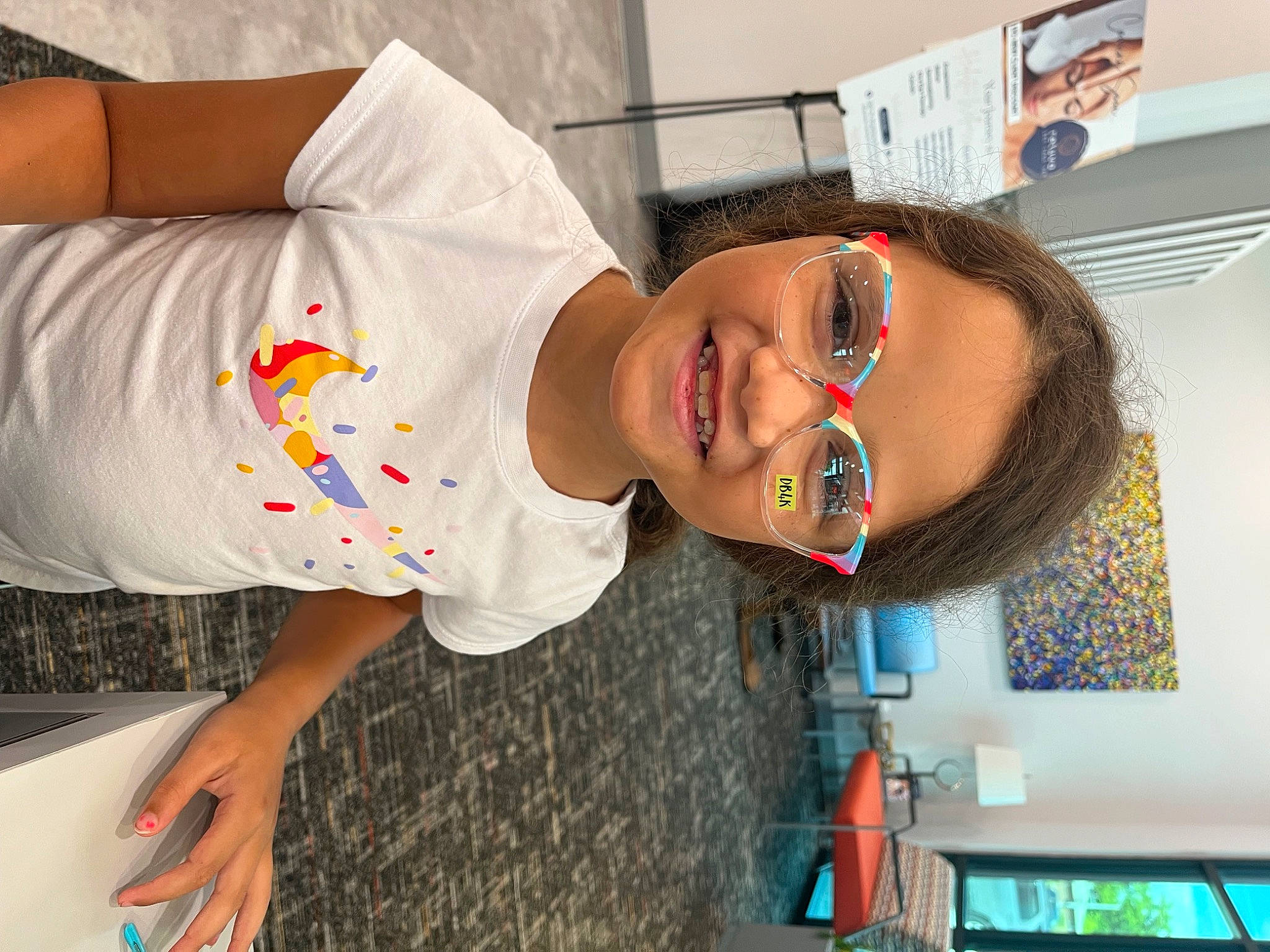 Amorra is registered to the contest to win money with this photo: child, elbow, eyewear, fun, glasses, happy, hat, joy, mouth, person, room, sleeve, smile, t_shirt, toddler, vacation, vision_care