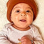 baby, infant, face, hat, knit_hat, bracelet, hand, long_sleeve, white_background, cute, smiling, portrait, closeup, child, skin, apparel, lying_down, happy, person, warm