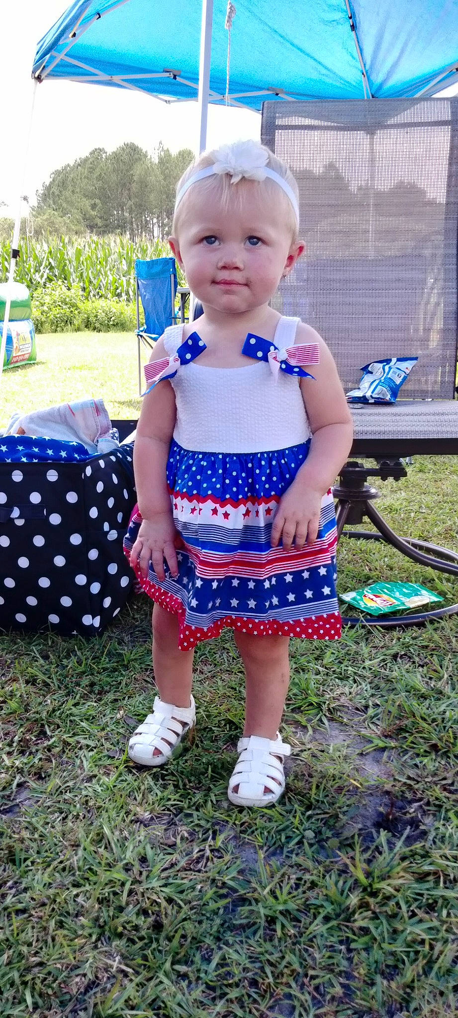 Katelynn is registered to the contest to win money with this photo: automotive_wheel_system, baby, baby_toddler_clothing, blue, child, electric_blue, fun, garden, grass, happy, leisure, pattern, person, plant, recreation, sandal, sitting, sky, smile, summer