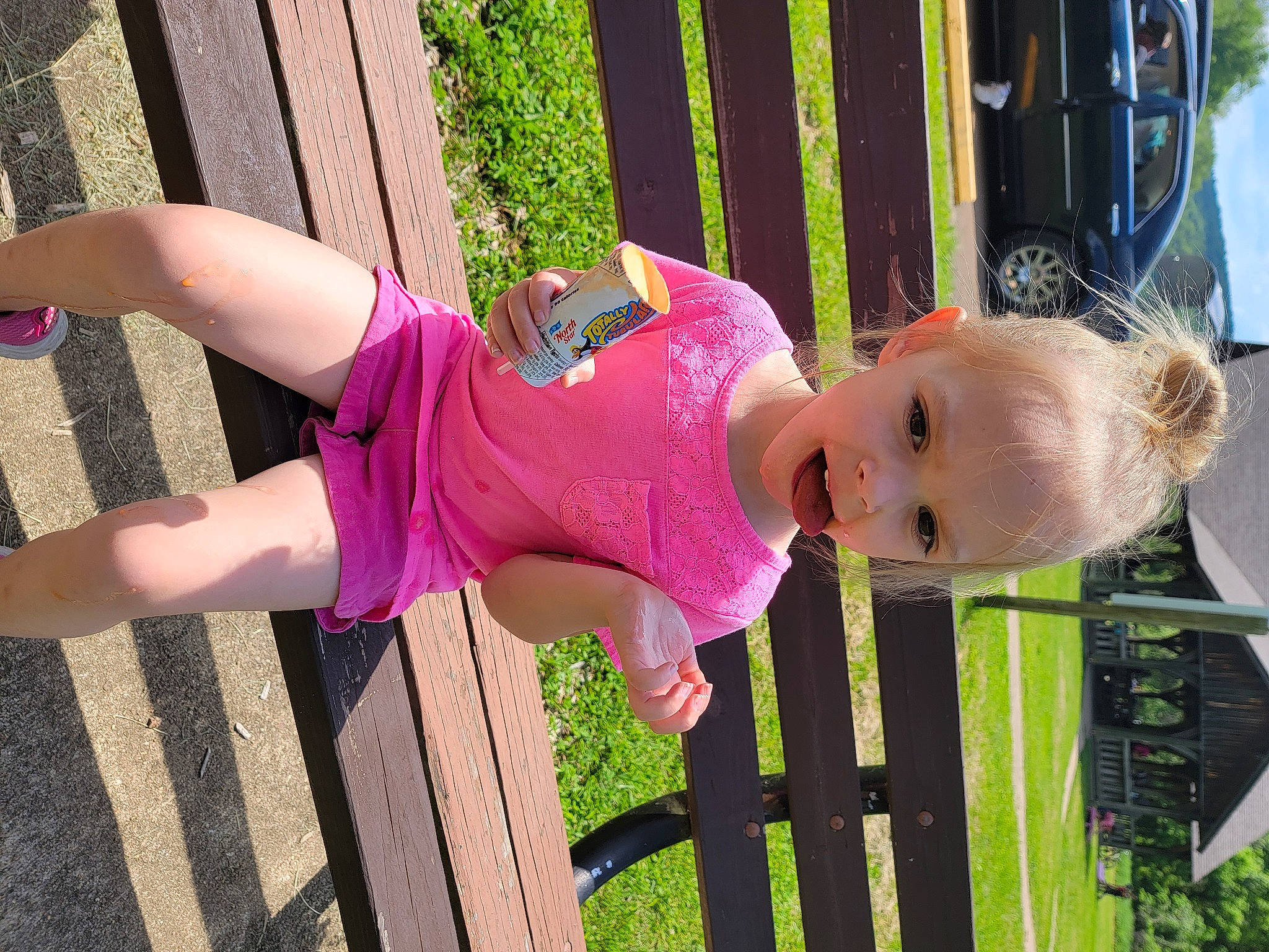 Taliah is registered to the contest to win money with this photo: baby_toddler_clothing, car, child, facial_expression, fence, fun, grass, happy, hat, leisure, magenta, person, pink, plant, purple, smile, textile, thigh, toddler, violet