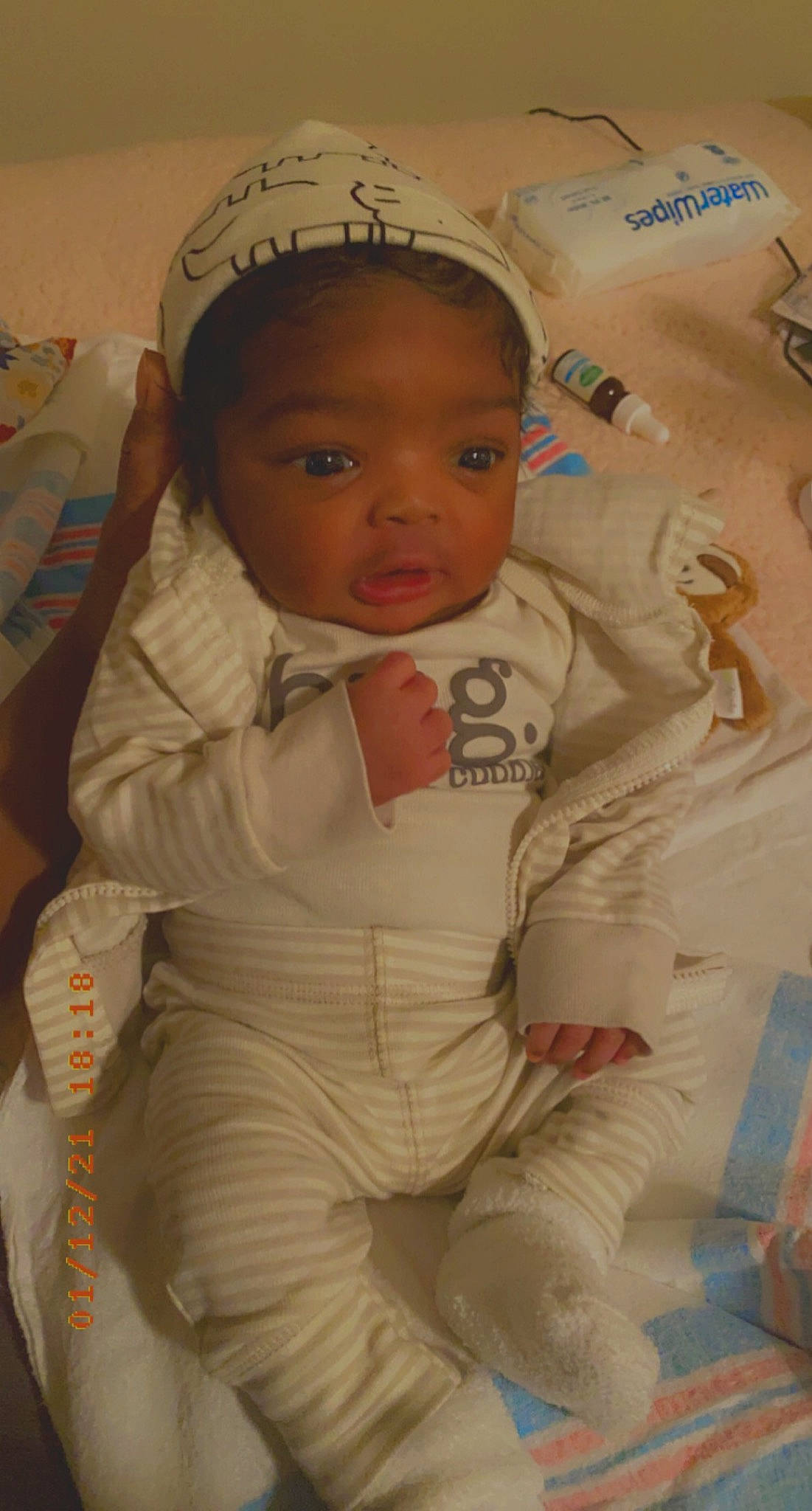 Dakari is registered to the contest to win money with this photo: arm, baby, baby_toddler_clothing, cheek, child, comfort, eye, face, finger, fun, head, linens, mammal, nose, outerwear, person, product, skin, sleeve, thumb