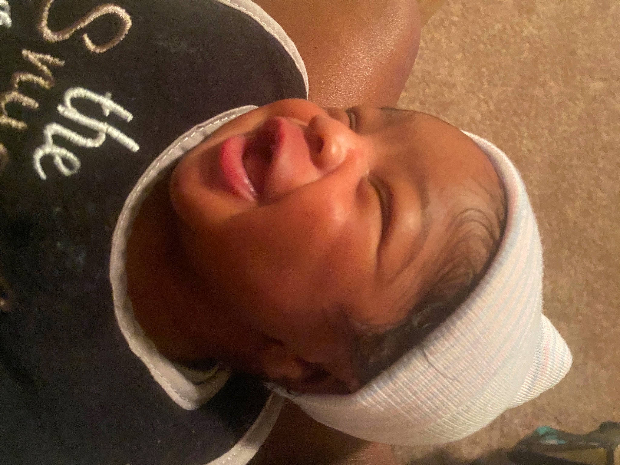Dakari is registered to the contest to win money with this photo: baby, baby_laughing, baseball_cap, cap, cheek, comfort, ear, eye, eyebrow, forehead, fun, happy, headgear, headwear, jaw, lip, neck, nose, person, sleeve