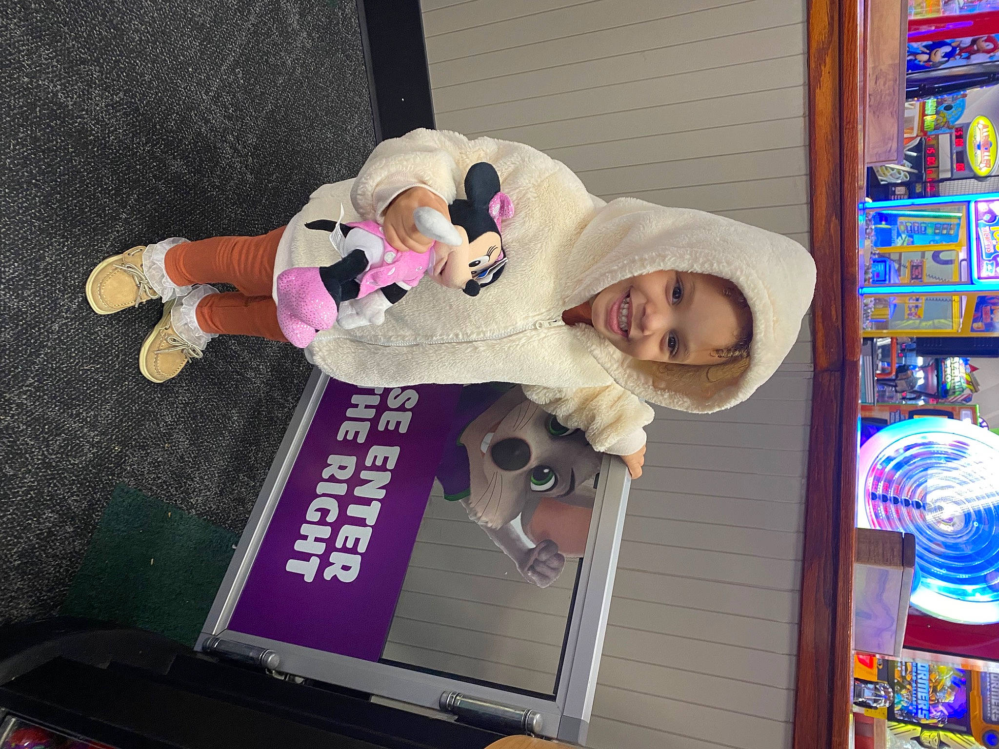 Kyla is registered to the contest to win money with this photo: building, child, fun, fur, gadget, hat, headwear, joy, laptop, machine, magenta, person, pink, room, shelf, smile, stuffed_toy, toddler, toy