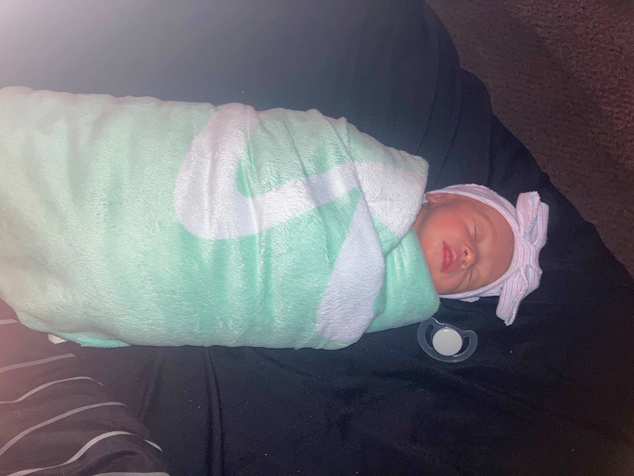 Kayleen is registered to the contest to win money with this photo: baby, baby_products, baby_sleeping, baby_toddler_clothing, child, comfort, elbow, foot, hat, head, headwear, human_body, human_leg, knee, linens, person, room, skin, sleeve, sock