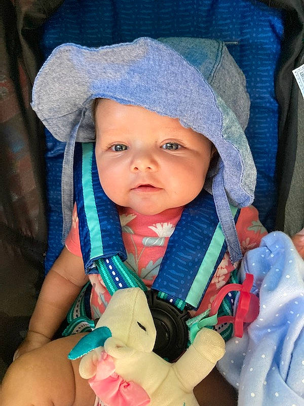 Elsie is registered to the contest to win money with this photo: azure, baby, baby_carriage, baby_products, baby_safety, baby_toddler_clothing, beauty, cheek, child, comfort, electric_blue, finger, fun, hand, headwear, iris, organ, people, person, product