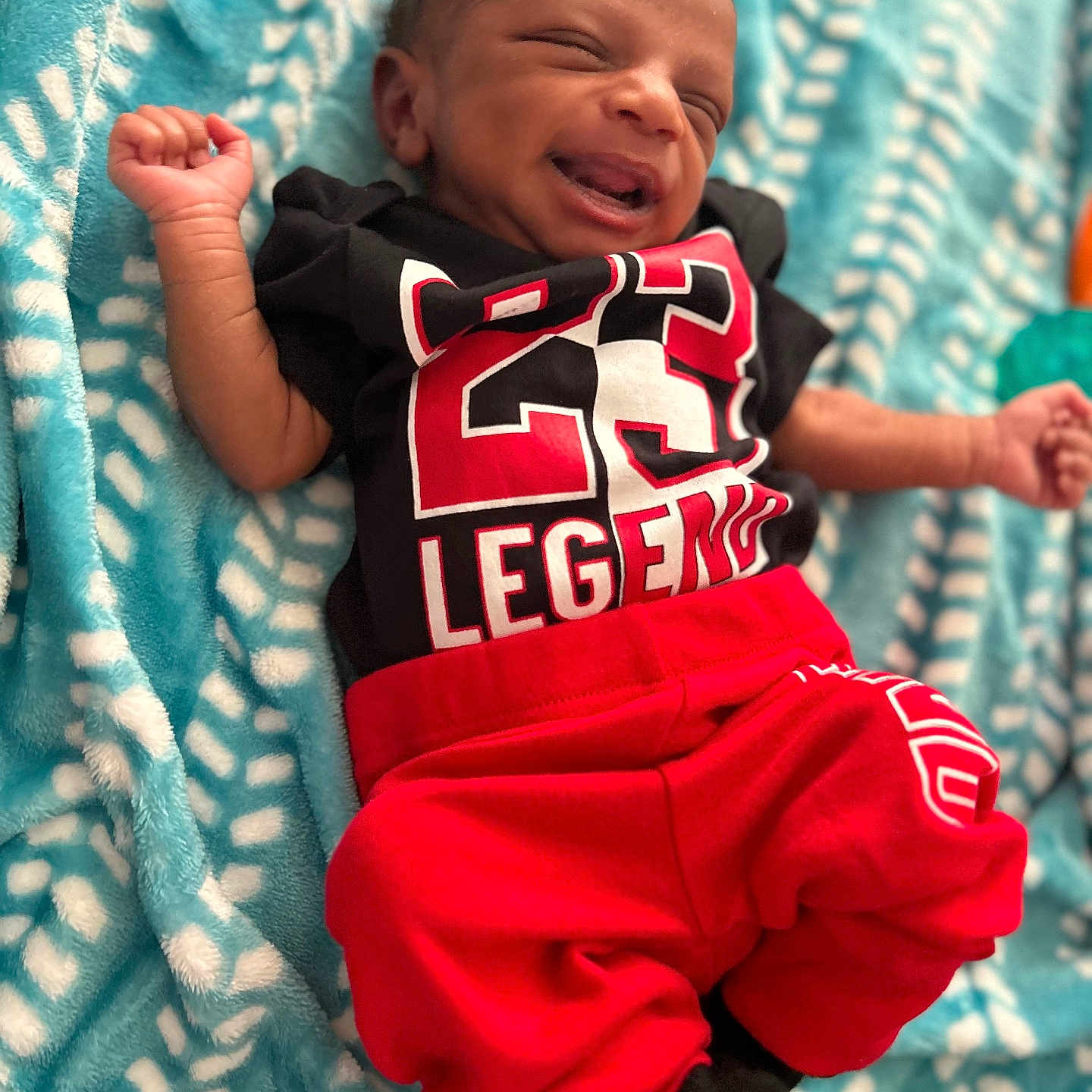 Noah is registered to the contest to win money with this photo: baby, blanket, bodypart, clothing, face, finger, furniture, glove, hand, happy, head, newborn, pants, person, photography, portrait, quilt, shorts, sleeping, t_shirt