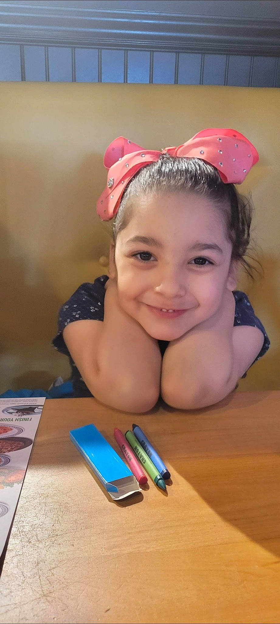 Izzy is registered to the contest to win money with this photo: cap, child, desk, eyelash, fashion_accessory, fun, happy, headband, headpiece, joy, nail, office_supplies, pen, person, personal_protective_equipment, recreation, smile, stationery, table, toddler