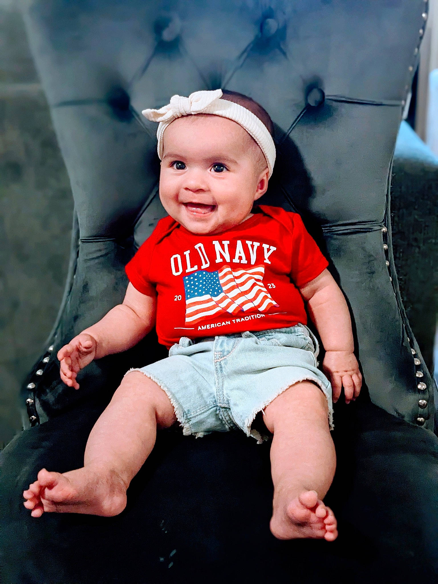 Kayla is registered to the contest to win money with this photo: baby, baby_toddler_clothing, cap, child, costume_hat, fashion_accessory, finger, flash_photography, fun, grass, happy, hat, human_leg, joy, person, sitting, skin, sleeve, smile, t_shirt