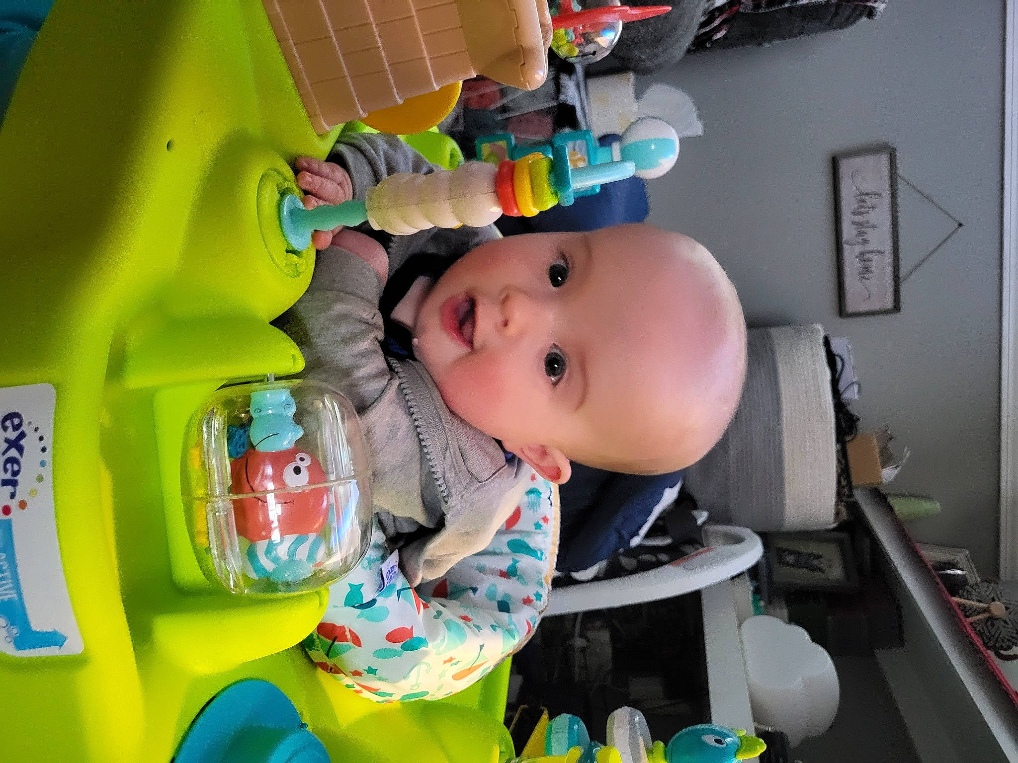 Jax is registered to the contest to win money with this photo: baby, baby_products, baby_safety, baby_toddler_clothing, baby_toys, child, drinkware, fun, person, plastic, play, room, surprise, toddler, toy, yellow
