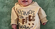 Lennon joined the competition — help win amazing prizes! apparel, baby, baby_girl, bow, child, clothing, cozy, cute, green_blanket, happy, headband, indoors, infant, lying_down, onesie, person, portrait, smiling, soft_texture, text_on_clothing