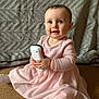 baby, child, pink_dress, toy, carpet, blanket, indoor, sitting, cute, smiling, long_sleeve, knitwear, white_tights, small_hands, blue_eyes, face, infant, portrait, happy, cozy