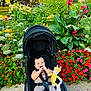 Yassine a rejoint le concours — aidez-le/la à gagner de superbes lots ! baby, bench, child, colorful, daytime, flower_bed, giraffe, grass, greenery, happy, nature, outdoor, park, plants, playful, smiling, stroller, sunlight, toy, urban