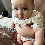 Theodore joined the competition — help win amazing prizes! baby, infant, child, person, holding, arm, face, eyes, skin, clothing, indoor, bed, blanket, adult, hand, cute, soft, curious, closeup, portrait