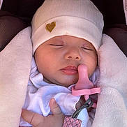 Aliya is registered to the contest to win money with this photo: baby, sleeping, pacifier, blanket, hat, infant, cute, peaceful, soft, cozy, child, newborn, wrapped, resting, pink, white, closeup, face, hand, carseat