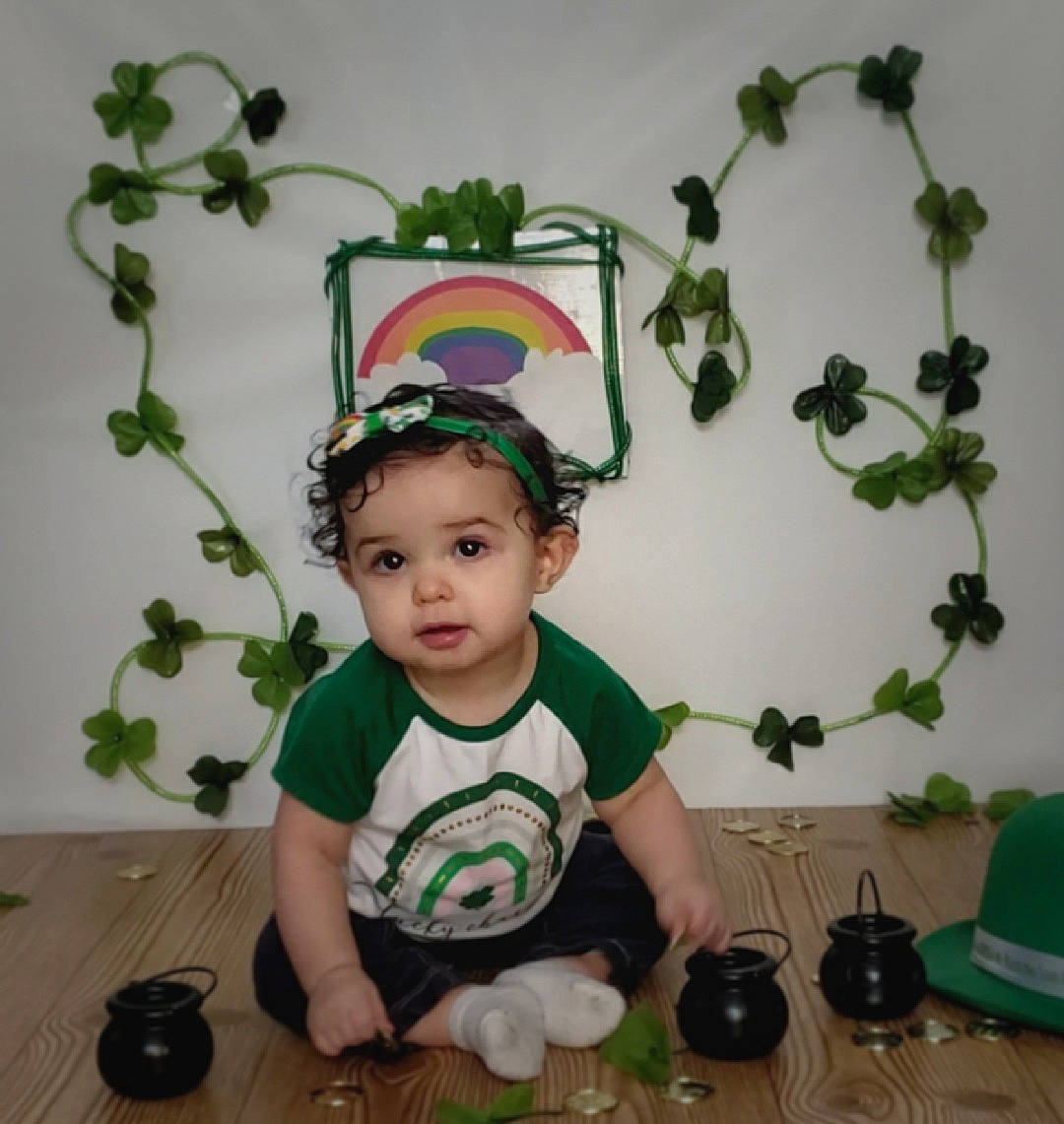Harper is registered to the contest to win money with this photo: baby, baby_toddler_clothing, child, flowerpot, fun, grass, green, happy, hat, holiday, houseplant, human_body, person, plant, room, shorts, sitting, sleeve, t_shirt, table