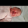 baby, baby_girl, bed, blanket, child, clothing, cute, face, head, indoors, infant, newborn, newborn_baby, person, pink_sweater, resting, sleeping, smiling, soft, young