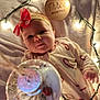 baby, infant, three_months, headband, bow, candy_cane, onesie, blanket, fairy_lights, soft_lighting, wooden_sign, holiday_theme, cute, face, child, portrait, indoors, cozy, newborn, celebration