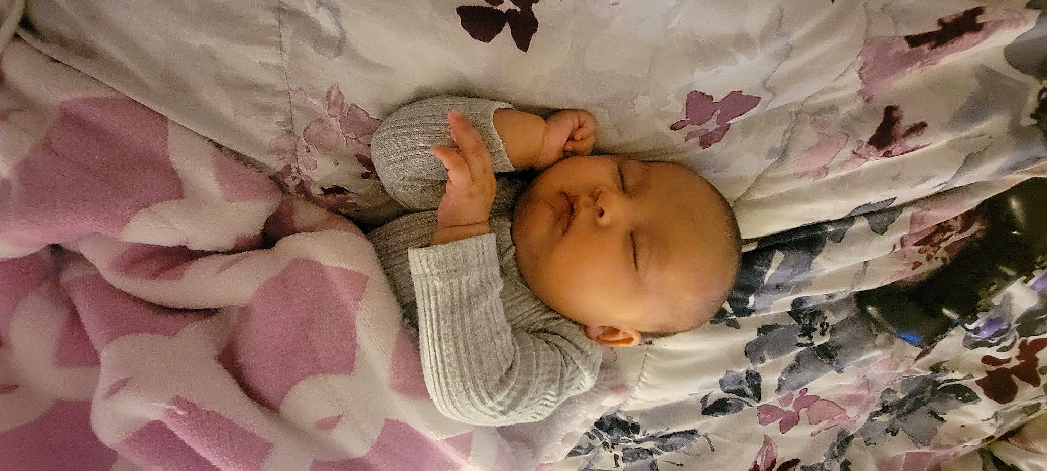 Elliana is registered to the contest to win money with this photo: arm, baby, baby_products, baby_sleeping, baby_toddler_clothing, cheek, child, comfort, eye, face, hand, head, linens, mouth, pattern, person, pink, product, skin, textile