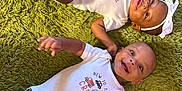 Ellagrace is registered to the contest to win money with this photo: baby, infant, toddler, child, onesie, headband, socks, carpet, green_carpet, smiling, lying_down, cute, matching_outfits, indoor, two_babies, happy, portrait, person, newborn, baby_clothes