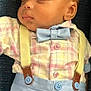 Elias is registered to the contest to win money with this photo: baby, sleeping, boy, plaid_shirt, bow_tie, suspenders, pastel_colors, cute, infant, portrait, close_up, fashion, clothing, relaxing, peaceful, child, face, head, indoors, resting