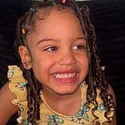Estelle is registered to the contest to win money with this photo: child, smile, braids, hair_beads, yellow_dress, butterfly_pattern, flower_pattern, happy, portrait, closeup, face, young, girl, cute, joyful, indoor, person, childhood, fashion, colorful