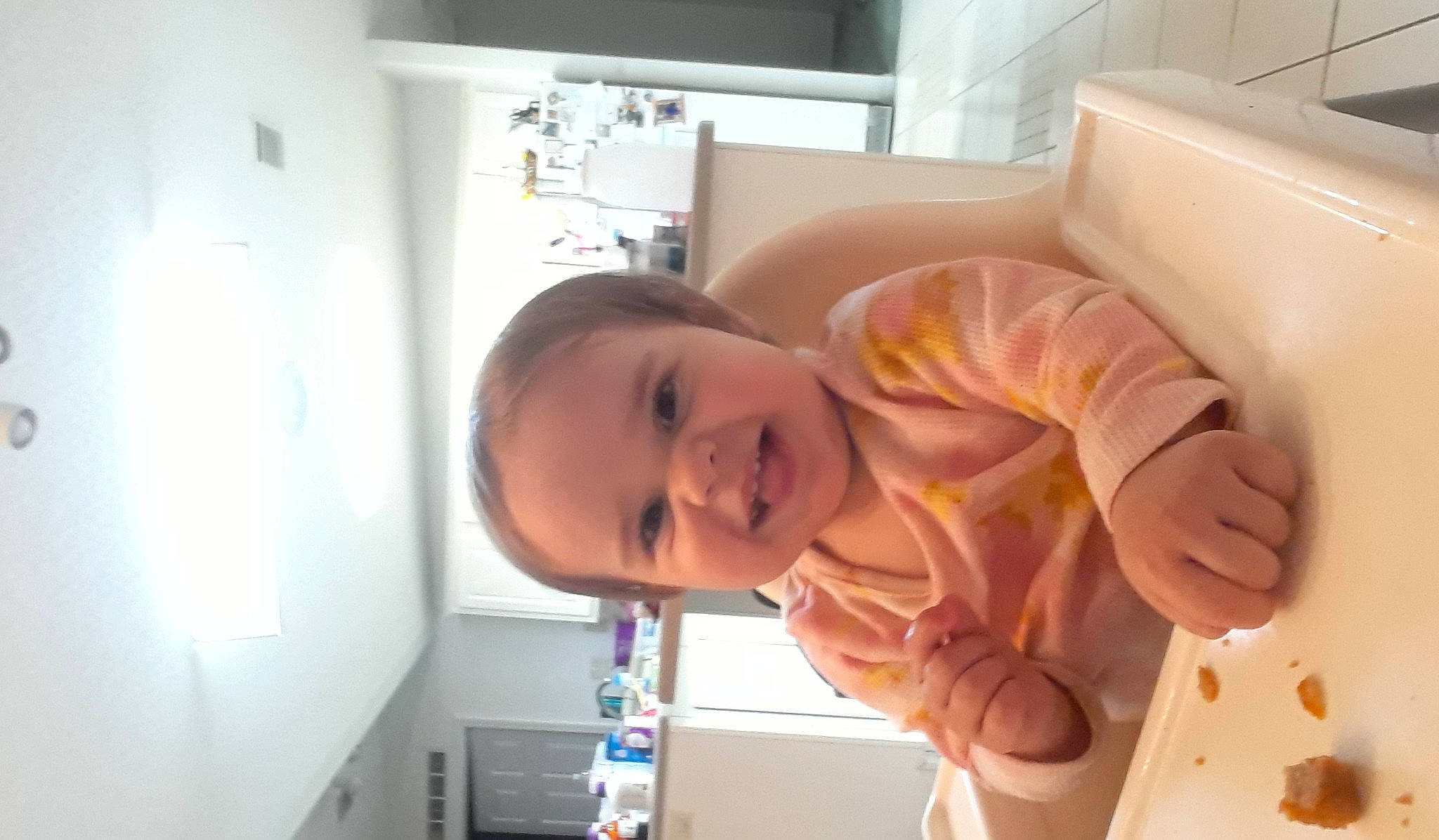 Saphira is registered to the contest to win money with this photo: arm, baby, baby_products, baby_safety, chair, chest, child, comfort, ear, fun, happy, jaw, joy, nose, person, room, smile, t_shirt, thumb, toddler