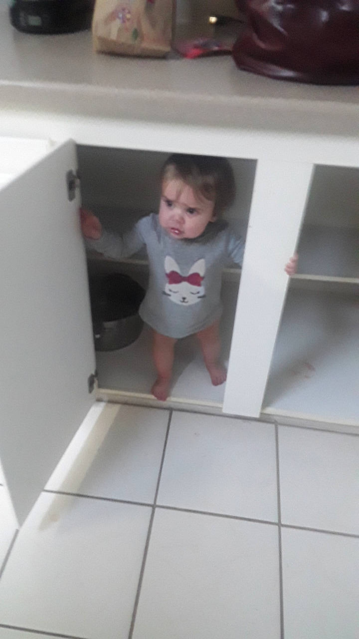 Saphira is registered to the contest to win money with this photo: baby, baby_toddler_clothing, ceiling, child, floor, flooring, fun, hardwood, human_leg, material_property, person, rectangle, room, shorts, sitting, sock, stairs, t_shirt, thigh, toddler