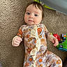 Ainsley joined the competition — help win amazing prizes! baby, carpet, floral_onesie, infant, toys, floor, child, ruffles, cute, lying_down, play_area, colorful, plastic, indoor, young_child, footed_pajamas, expression, curious, person, home