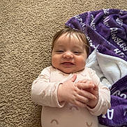Ainsley joined the competition — help win amazing prizes! baby, infant, carpet, blanket, purple, smiling, happy, hands, clapping, foot, cozy, indoors, child, cute, person, lying_down, soft, clothing, pattern, relaxed