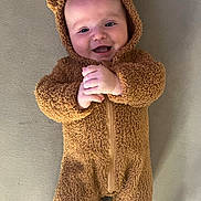 Archie joined the competition — help win amazing prizes! baby, infant, smiling, bear_costume, fuzzy_clothing, cute, hands_clasped, lying_down, soft_surface, happy, child, portrait, one_person, indoors, warm_clothing, baby_face, adorable, cozy, infant_clothing, expression