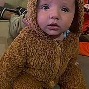 Archie joined the competition — help win amazing prizes! baby, child, costume, bear_costume, fuzzy_clothing, indoor, couch, curious, cute, infant, portrait, seated, wide_eyes, soft_texture, casual, playful, adorable, expression, young_child, cozy
