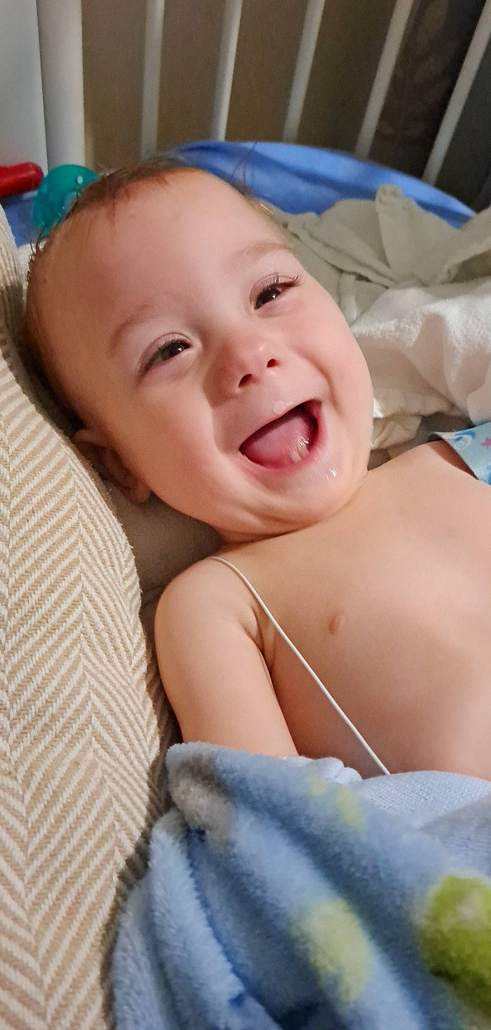 Jason is registered to the contest to win money with this photo: baby, baby_laughing, bed, blue, cheek, child, comfort, event, gesture, happy, jaw, linens, neck, nose, person, room, skin, smile, textile, thumb