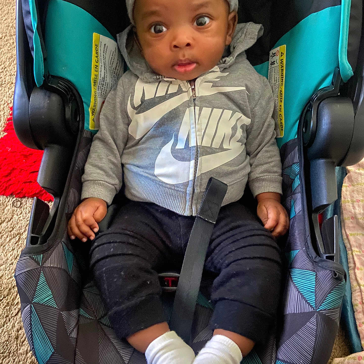 Lano is registered to the contest to win money with this photo: baby, car, car_interior, clothing, coat, face, happy, head, hosiery, jacket, pants, person, photography, portrait, sitting, sleeve, smile, sock, transportation, vehicle