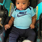 Lano is registered to the contest to win money with this photo: baby, blackhair, clothing, cushion, face, footwear, hair, happy, head, homedecor, pants, person, photography, portrait, shoe, shorts, sitting, sleeve, stroller, t_shirt