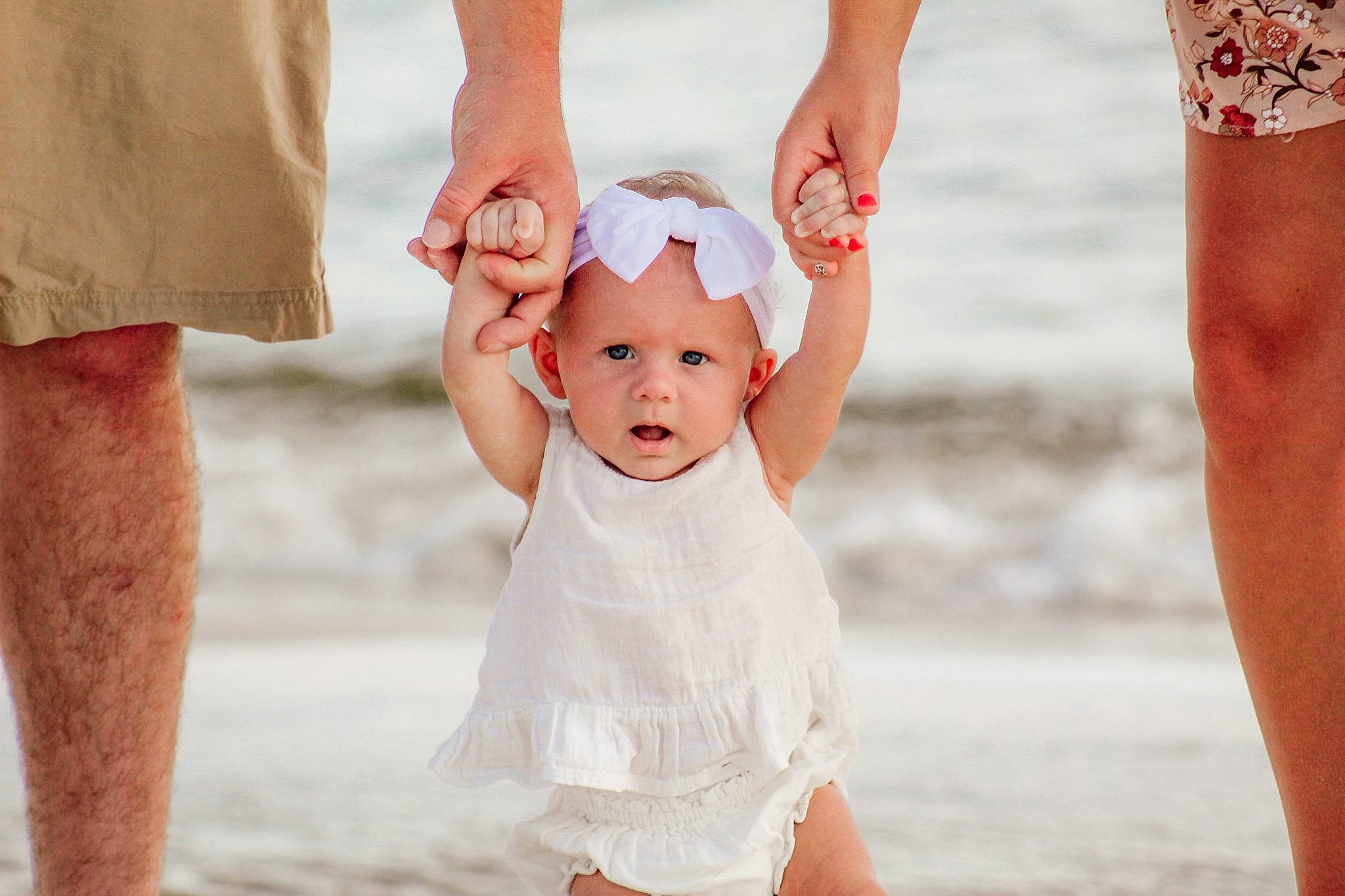 Hadleigh joined the competition — help win amazing prizes! baby_toddler_clothing, barefoot, beach, body_of_water, fun, gesture, hand, happy, headwear, human_body, interaction, joint, leg, people_in_nature, people_on_beach, person, sand, shore, sleeve, standing