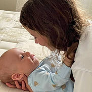 Lily participe au concours pour gagner de l'argent avec cette photo : baby, child, infant, face, person, cuddling, bed, mattress, pajamas, sleepwear, holding, closeup, family, love, tenderness, indoor, portrait, skin, hair, expression