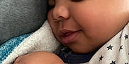 Ezrah joined the competition — help win amazing prizes! baby, sleeping, blanket, cozy, child, smile, face, arm, skin, closeup, comfort, soft, cute, infant, resting, peaceful, warm, clothing, indoors, portrait