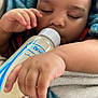 Ezrah joined the competition — help win amazing prizes! baby, sleeping, milk_bottle, blanket, hand, infant, peaceful, cozy, close_up, face, child, nap, comfort, soft_texture, indoors, cute, relaxation, skin, curly_hair, portrait