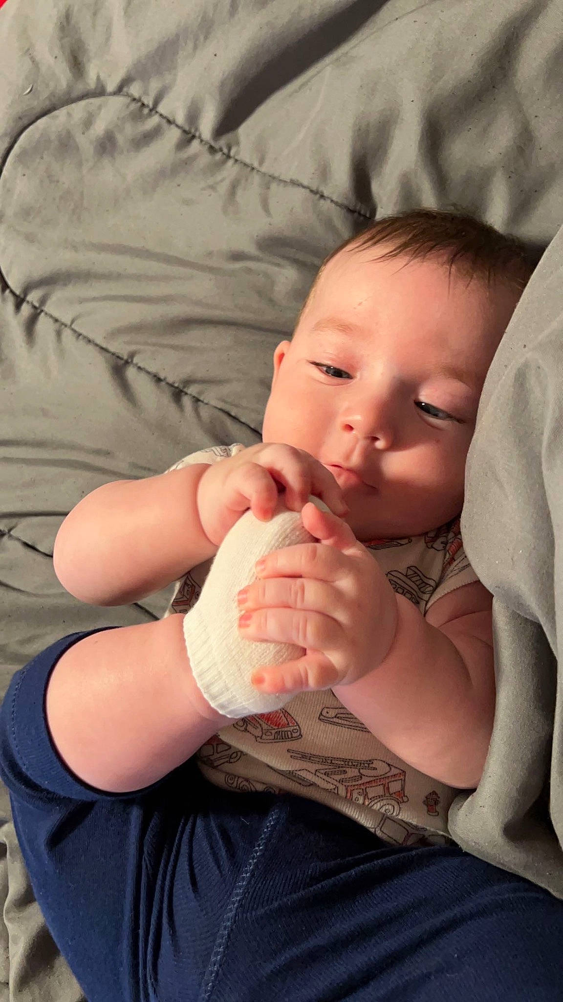 Myles is registered to the contest to win money with this photo: arm, baby, baby_toddler_clothing, cheek, chin, comfort, eye, finger, gesture, hand, mammal, mouth, nail, nose, person, skin, sleeve, stomach, thumb, toddler
