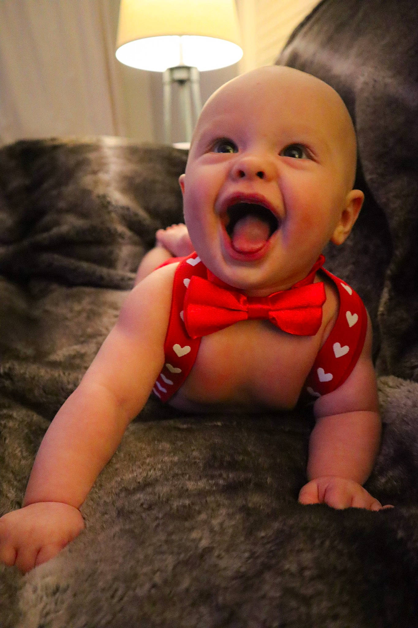 Jesse is registered to the contest to win money with this photo: baby, baby_toddler_clothing, cheek, comfort, eye, finger, flash_photography, flooring, gesture, happy, human_body, iris, lamp, lip, mouth, nose, person, skin, sleeve, smile