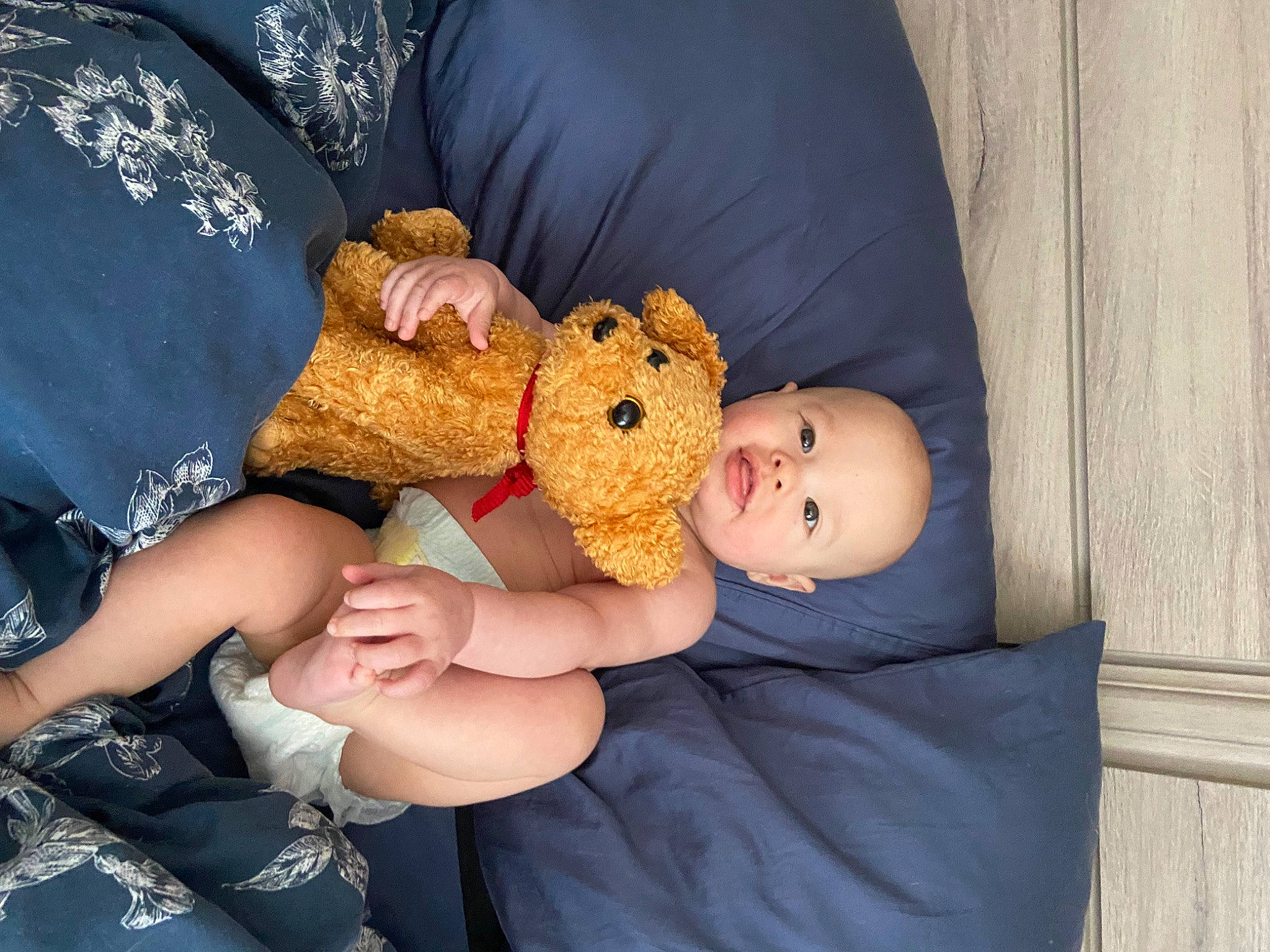 Jesse is registered to the contest to win money with this photo: abdomen, baby, baby_sleeping, baby_toddler_clothing, child, comfort, doll, gesture, happy, lap, nail, person, plush, room, sitting, stuffed_toy, textile, thumb, toddler, toy