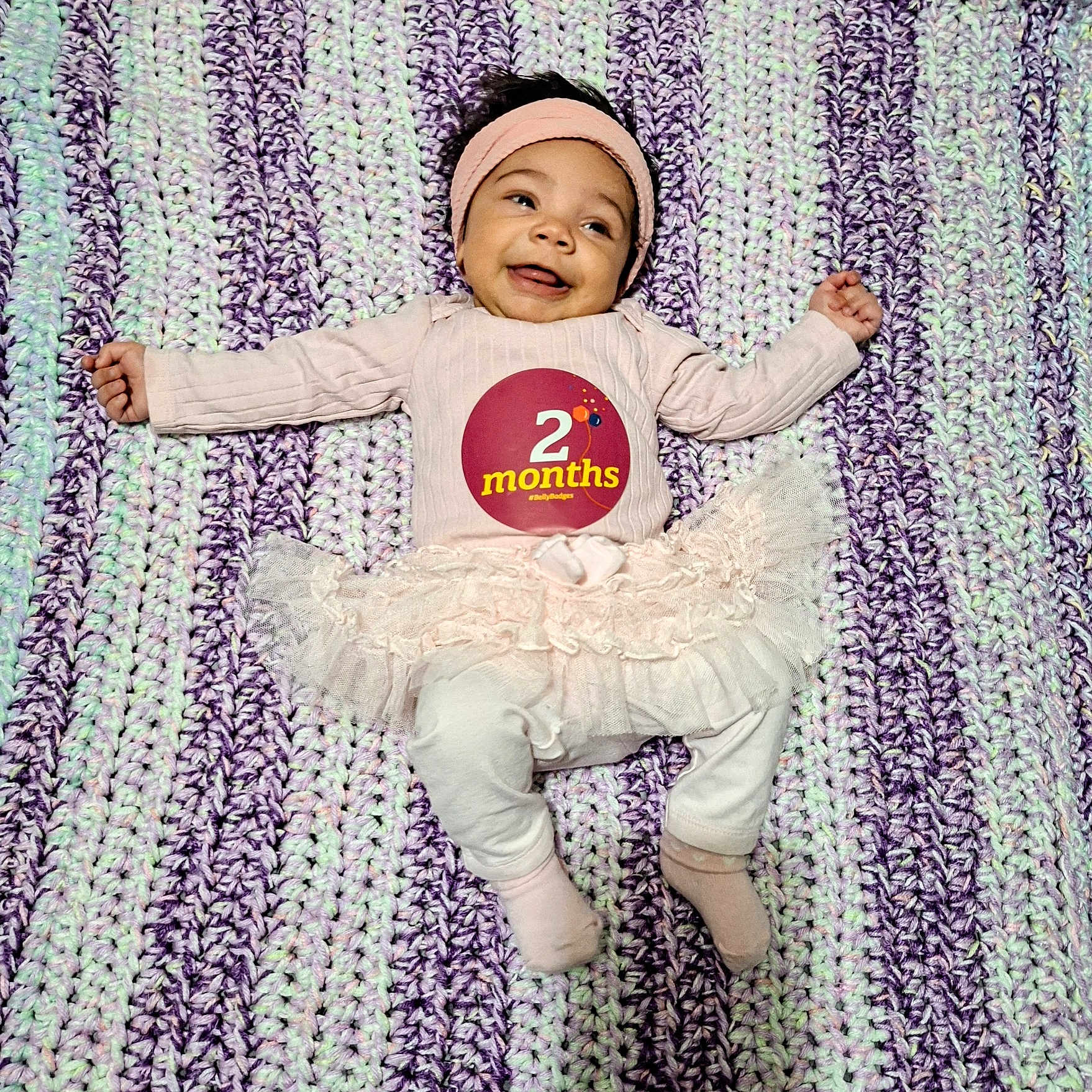 Serenity is registered to the contest to win money with this photo: baby, babylaughing, bonnet, cap, clothing, dancing, face, flower, happy, hat, head, homedecor, hosiery, pants, person, photography, plant, portrait, purple, sock