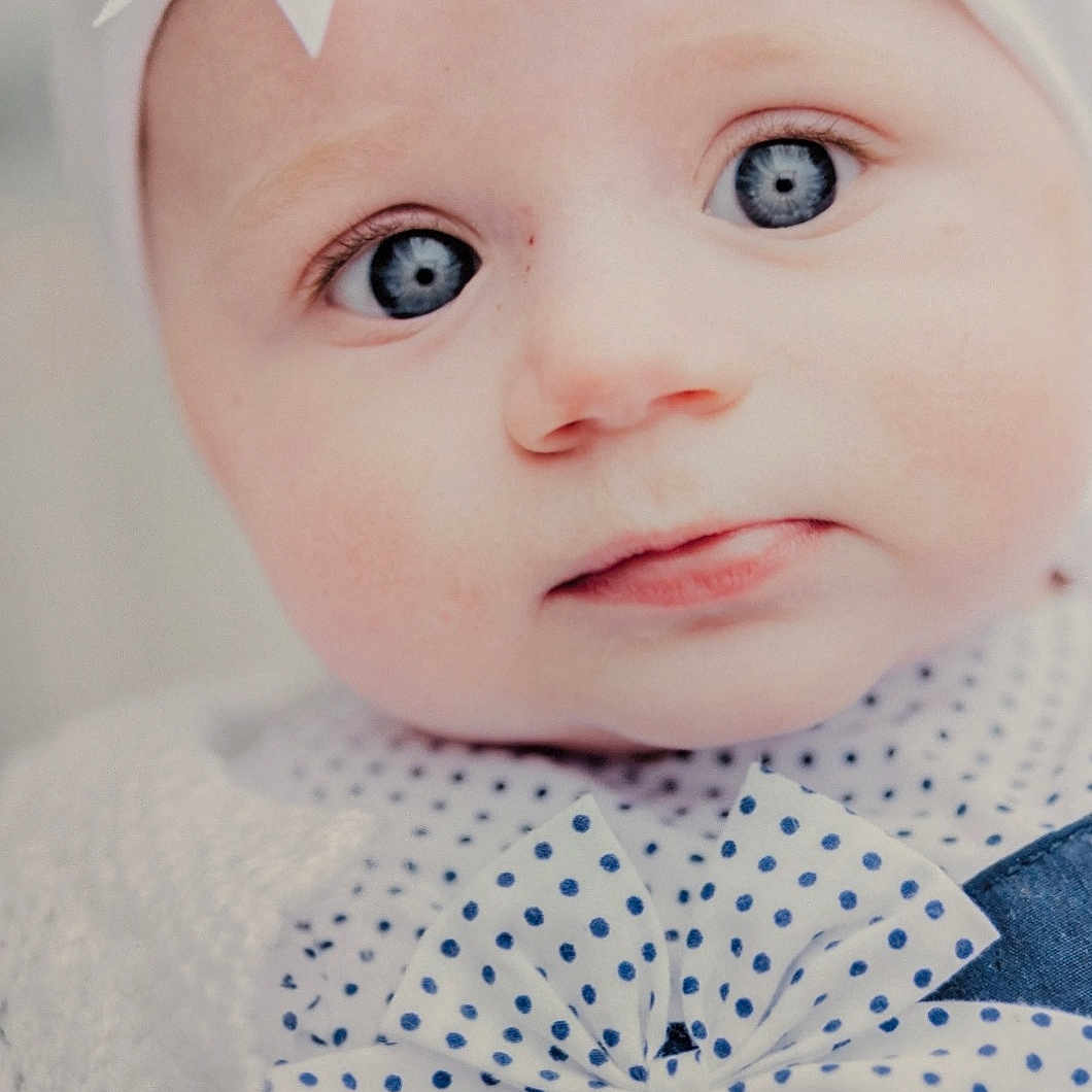 Ava-Grace is registered to the contest to win money with this photo: accessories, baby, bonnet, clothing, costume, doll, dress, face, formalwear, happy, hat, head, headband, newborn, person, photography, portrait, smile, tie, toy