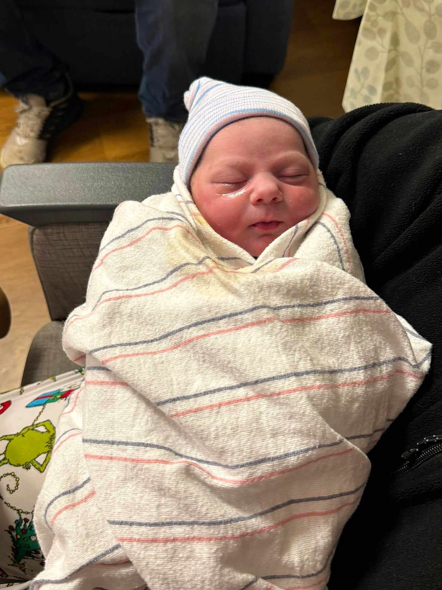 Zaylee is registered to the contest to win money with this photo: newborn, baby, blanket, hat, sleeping, indoor, person, face, human, clothing, pattern, striped, hospital, comfort, holding, resting, curtain, footwear, floor, seated