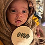 baby, infant, hoodie, brown, plaque, one_month, cozy, fuzzy, cute, portrait, child, newborn, hand, fabric, clothing, face, eyes, indoor, person, milestone