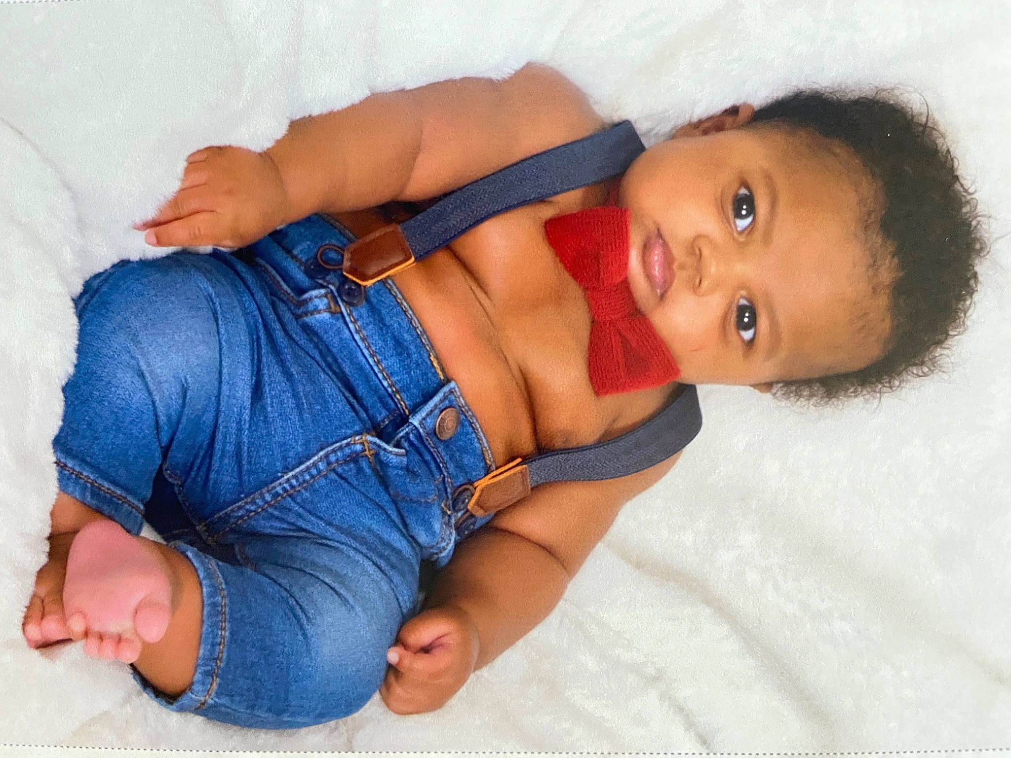 Tahj is registered to the contest to win money with this photo: arm, baby_toddler_clothing, cheek, chest, comfort, elbow, eye, head, human_body, joint, leg, mouth, muscle, neck, nose, person, shoulder, skin, sleeve, stomach